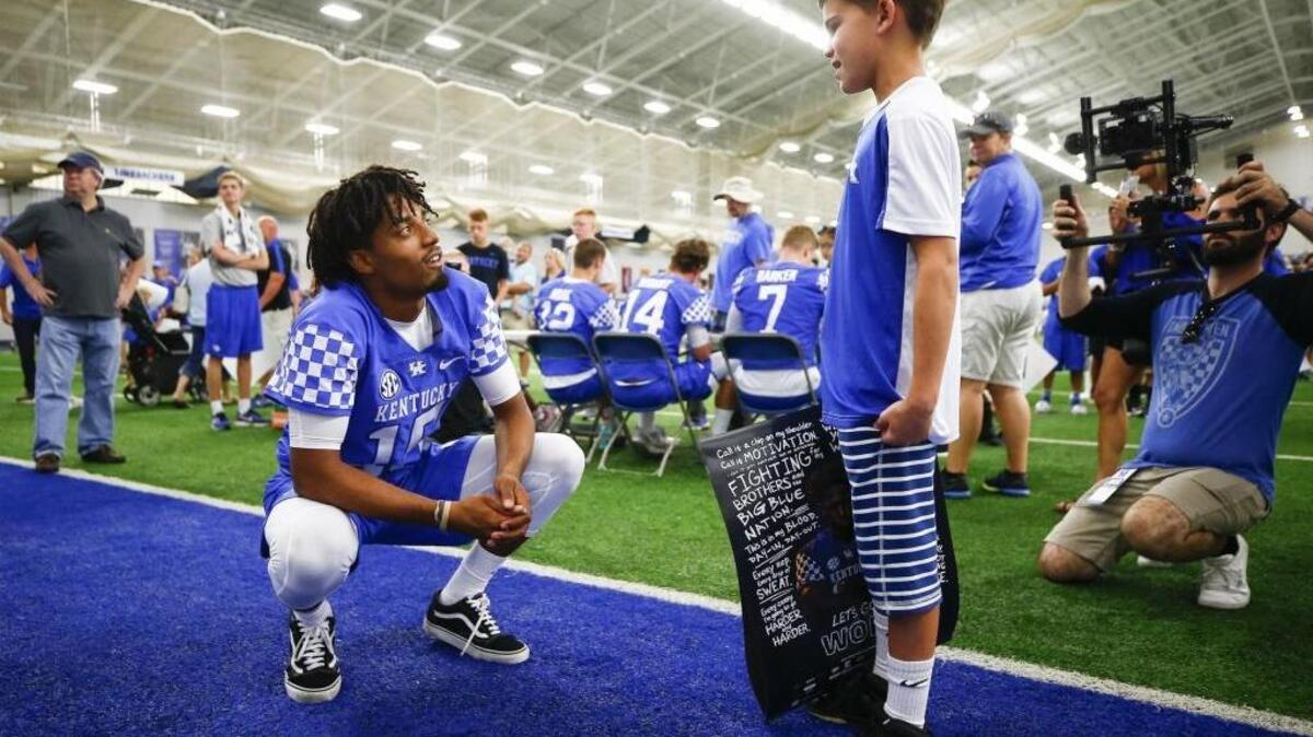 Kentucky quarterback Stephen Johnson speaks with Samuel Doster, 10, of Louisville, Ky., during UK Football Fan Day at Nutter Field House in Lexington, Ky., Saturday, Aug. 5, 2017. Johnson will be the starting quarterback when UK opens the season Sept. 2 at Southern Miss.