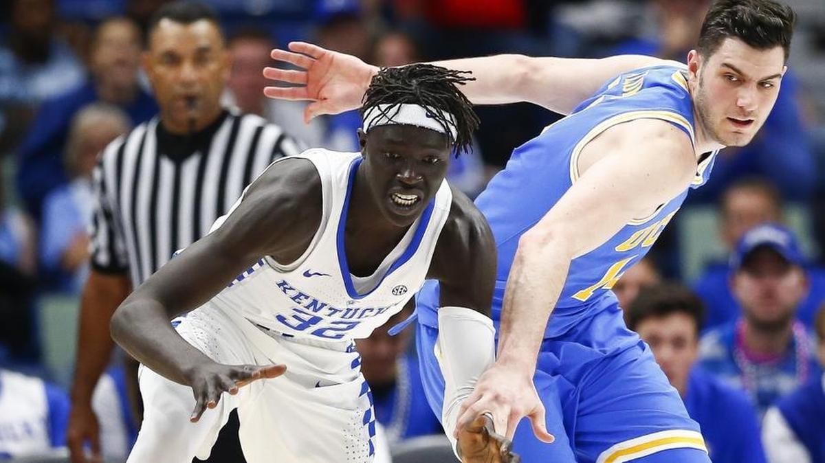 Kentucky forward Wenyen Gabriel (32) and UCLA forward Gyorgy Goloman (14) go for a loose ball during UCLA’s 83-75 win in the CBS Sports Classic at the Smoothie King Center in New Orleans, Saturday, Dec. 23, 2017.