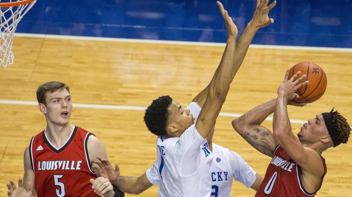 Kentucky Wildcats forward Skal Labissiere (1) defended Louisville Cardinals guard Damion Lee (0) as UK defeated UL 75-73 in Rupp Arena Saturday Dec. 26, 2015 in Lexington, Ky.