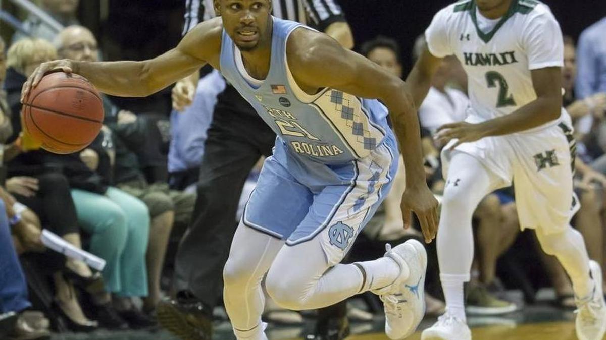 North Carolina guard Seventh Woods, left, brings the basketball up court as Hawaii guard Brocke Stepteau (2) looks on during the second half of North Carolina’s 83-6 win on Friday in Honolulu.
