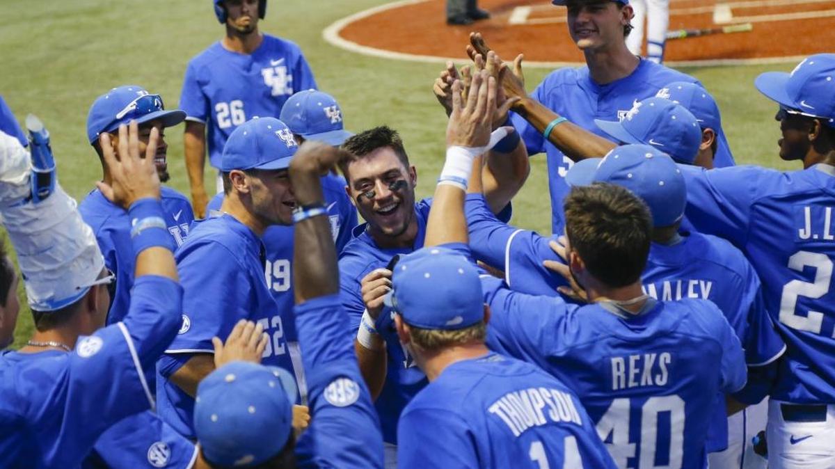 Kentucky’s Kole Cottam celebrates with teammates after scoring during 8-6 win over North Carolina State in the NCAA Regional at Cliff Hagan Stadium in Lexington, Ky on Sunday June 4, 2017.