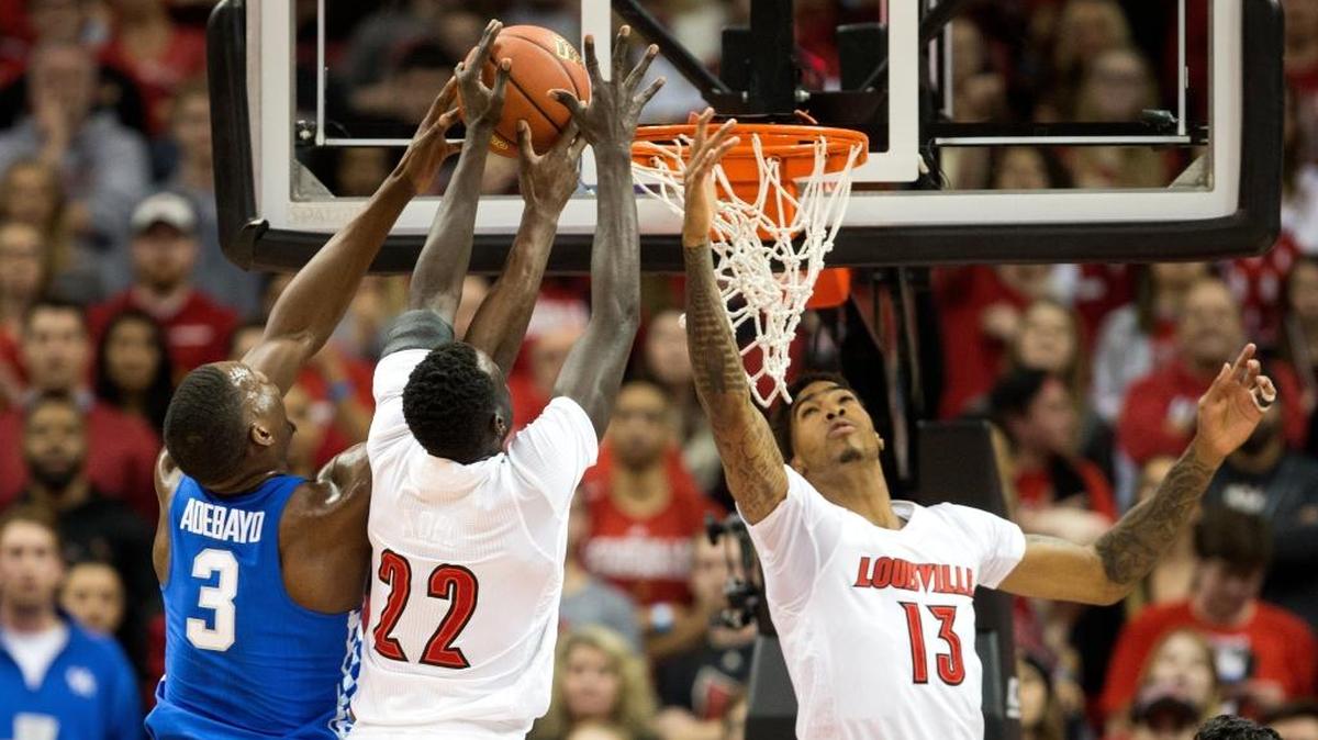 Kentucky forward Bam Adebayo (3) fights for the rebound with Louisville forwards Deng Adel (22) and Ray Spalding (13) during UK’s 73-70 loss to the Cards on at the KFC Yum! Center.