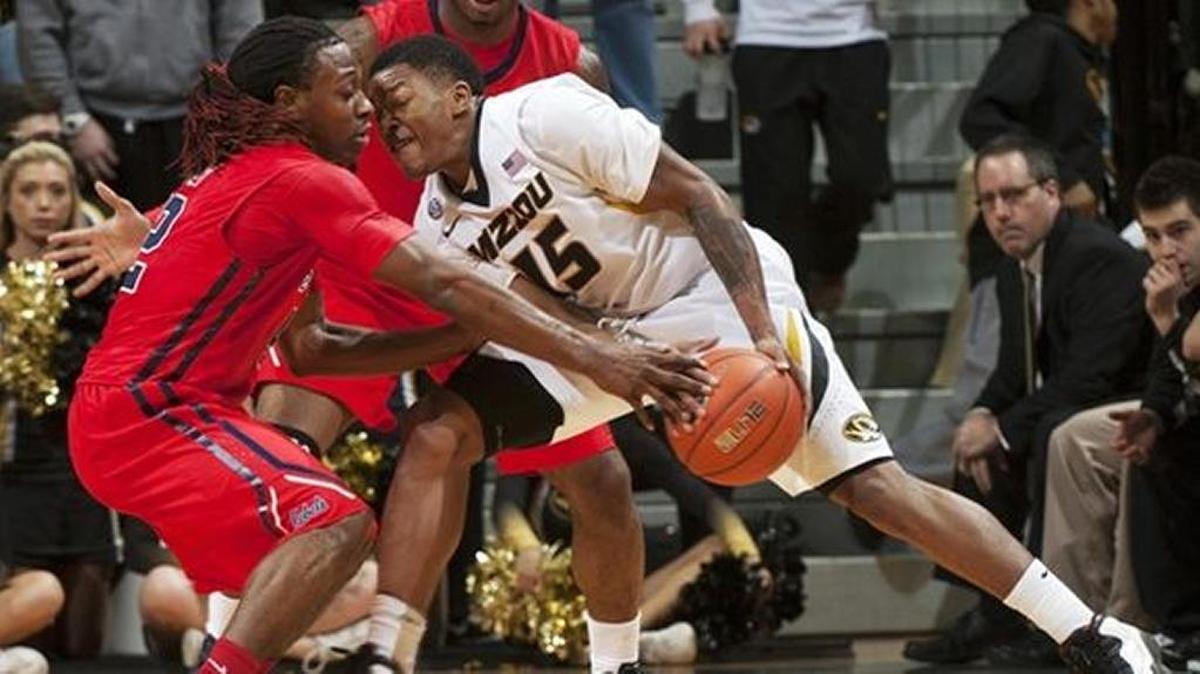Missouri's Wes Clark, right, tries to push past Mississippi's Stefan Moody, left, and Martavious Newby during the second half of an NCAA college basketball game Saturday, Jan. 31, 2015, in Columbia, Mo. Mississippi won 67-47.