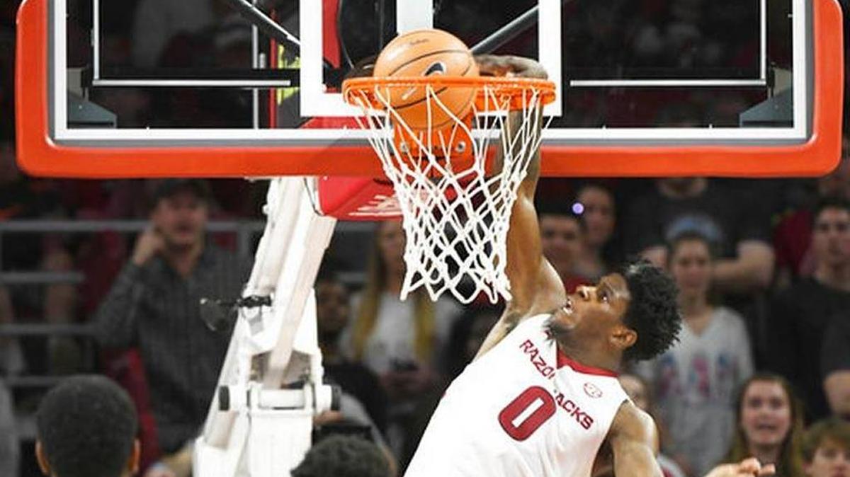 Arkansas guard Jaylen Barford goes up for a dunk over Texas A&M defenders during the second half the Razorbacks 94-75 win in an NCAA college basketball game Saturday, Feb. 17, 2018, in Fayetteville, Ark.