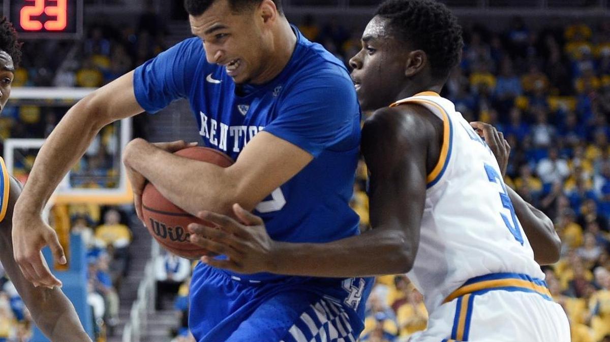 Kentucky guard Jamal Murray, left, attempts to move the ball past UCLA guard Aaron Holiday during the second half of an NCAA college basketball game in Los Angeles, Thursday, Dec. 3, 2015. UCLA won 87-77.