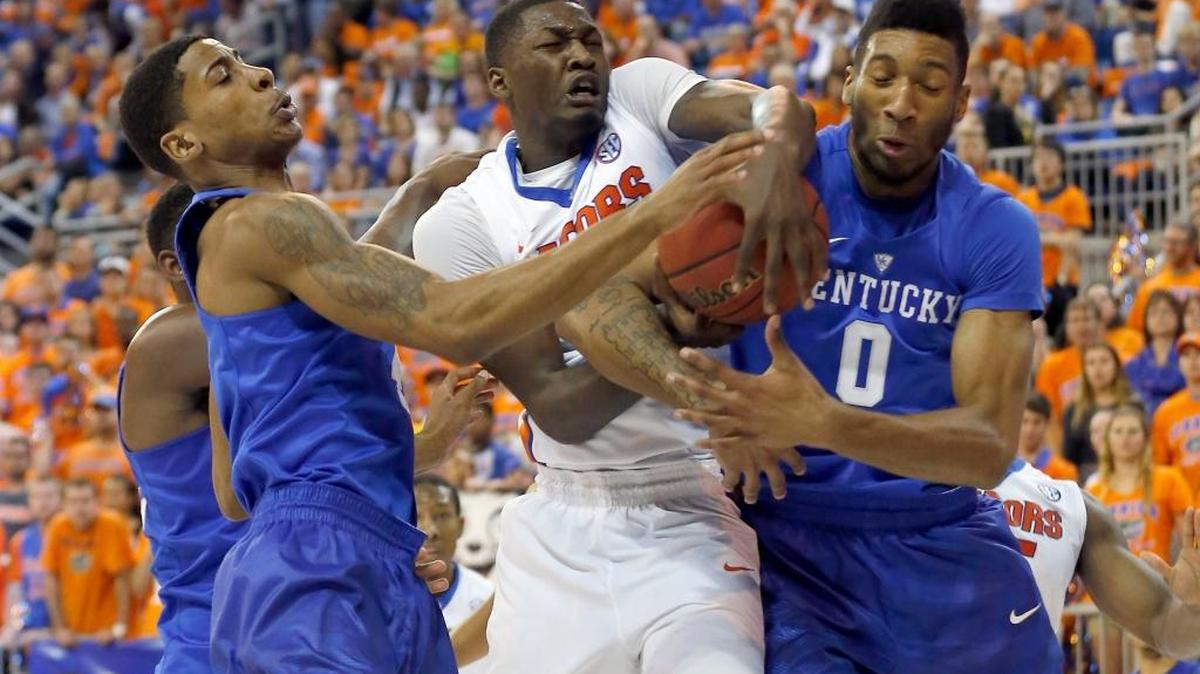 Kentucky Wildcats guard Charles Matthews (4) and Kentucky Wildcats forward Marcus Lee (0) battled Florida Gators forward Dorian Finney-Smith (10) for a rebound as the University of Kentucky played the University of Florida at the O'Connell Center, Gainesville, Fl., Tuesday, March 1, 2016.