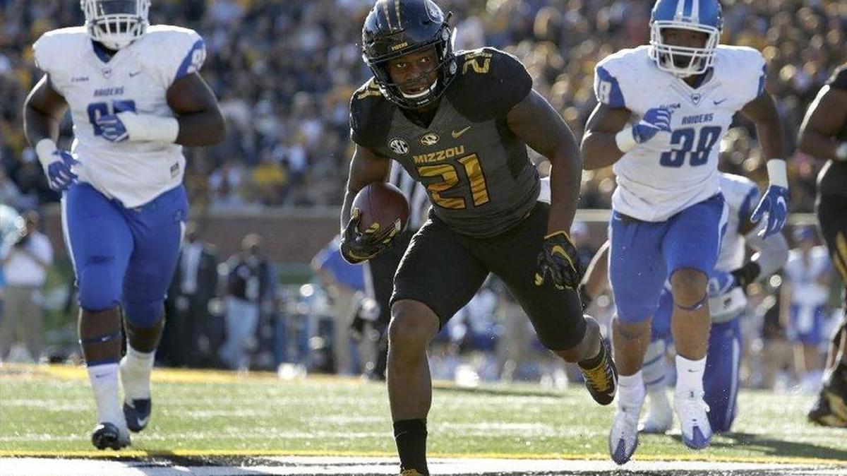 Missouri running back Ish Witter ran away from Middle Tennessee defenders Jimal McBride (left) and Malik Hawkins in Missouri’s 51-45 loss Saturday in Columbia. Witter took a big hit during the game but returned in the next series.