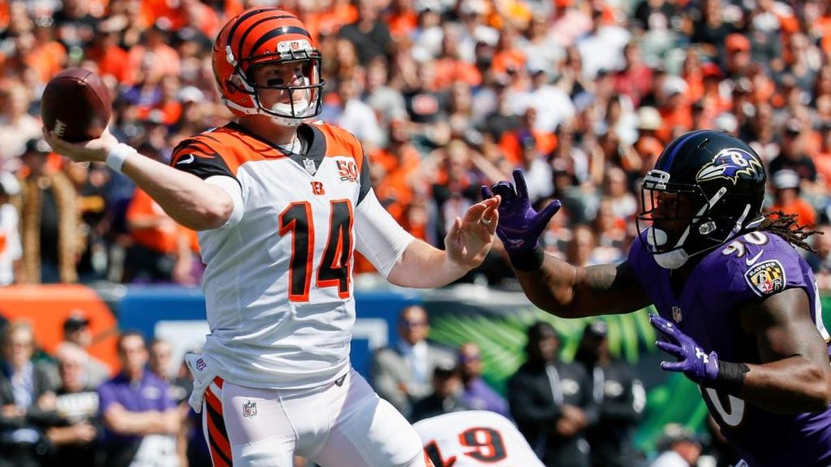 Cincinnati Bengals quarterback Andy Dalton (14) passes under pressure from Baltimore Ravens outside linebacker and former Kentucky Wildcats defensive end Za'Darius Smith (90) in the first half of an NFL football game, Sunday, Sept. 10, 2017, in Cincinnati. Baltimore won 20-0 as Dalton threw four interceptions.