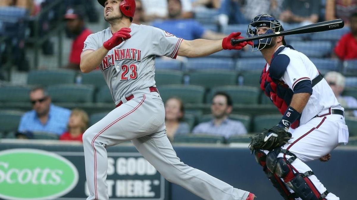Cincinnati Reds' Adam Duvall (23) follows through on a two-run home run as Atlanta Braves catcher A.J. Pierzynski watches during the first inning of a baseball game Monday, June 13, 2016, in Atlanta.