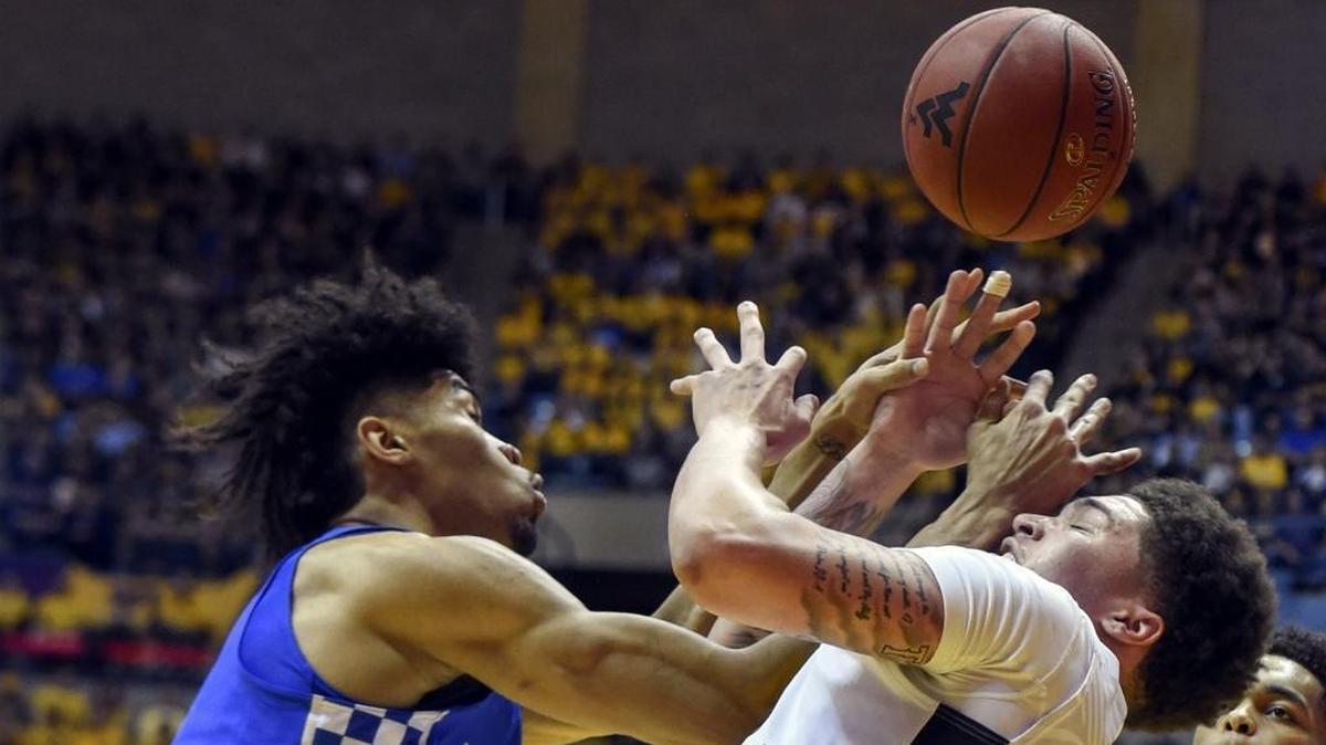 West Virginia forward Teddy Allen, front right, is fouled by Kentucky forward Nick Richards, left, during the first half of UK’s 83-76 win over the Mountaineers in an NCAA college basketball game Saturday, Jan. 27, 2018, in Morgantown, W.Va.