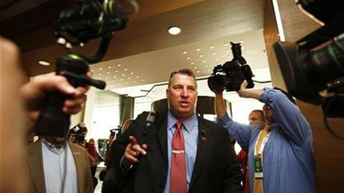 Arkansas football coach Bret Bielema makes his way through the crowd at the SEC Football Media Days this year at Hoover, Alabama.
