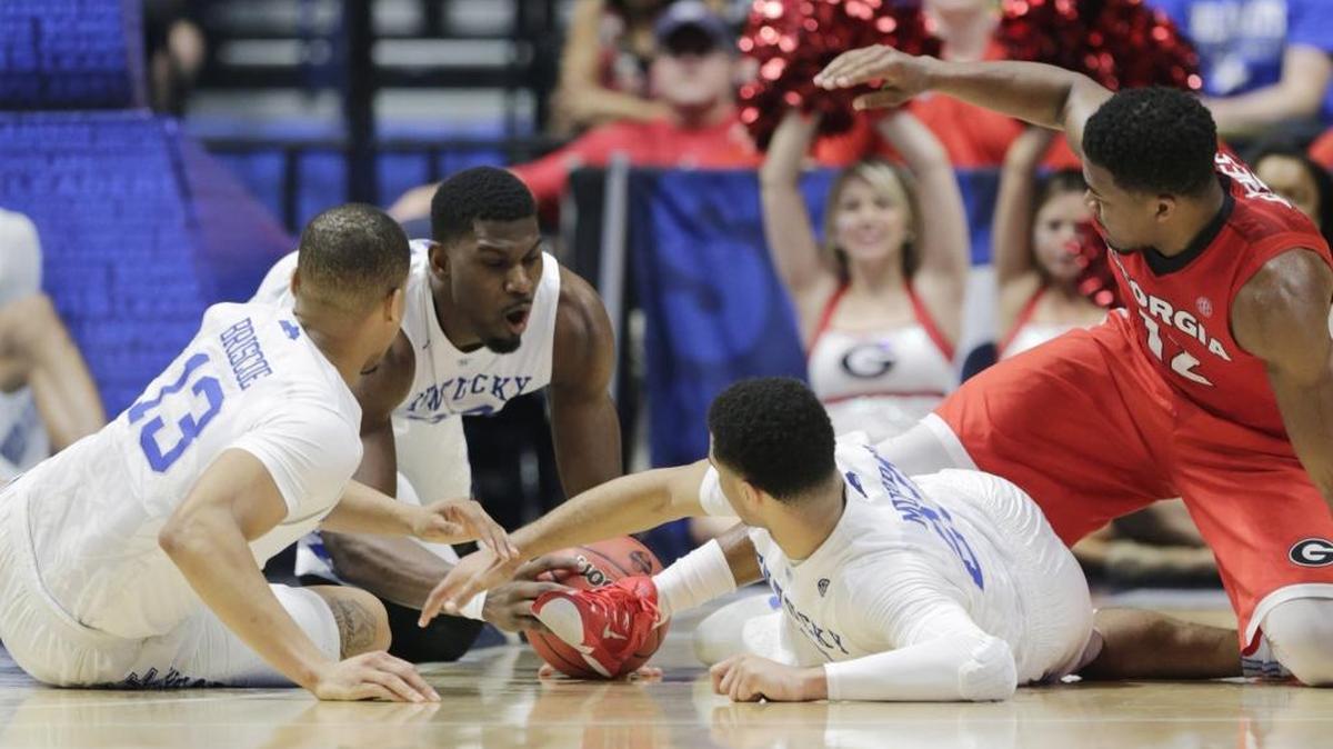 Kentucky forward Alex Poythress (22) joined Kentucky guard Isaiah Briscoe (13), left, and Kentucky guard Jamal Murray (23) for a ball scramble in the second half of the Kentucky vs Georgia SEC Men’s Basketball Tournament semifinal game at Bridgestone Arena in Nashville, Tenn., on March 12, 2016. Kentucky beat Georgia 93-80 and advance to the championship game against Texas A&M.