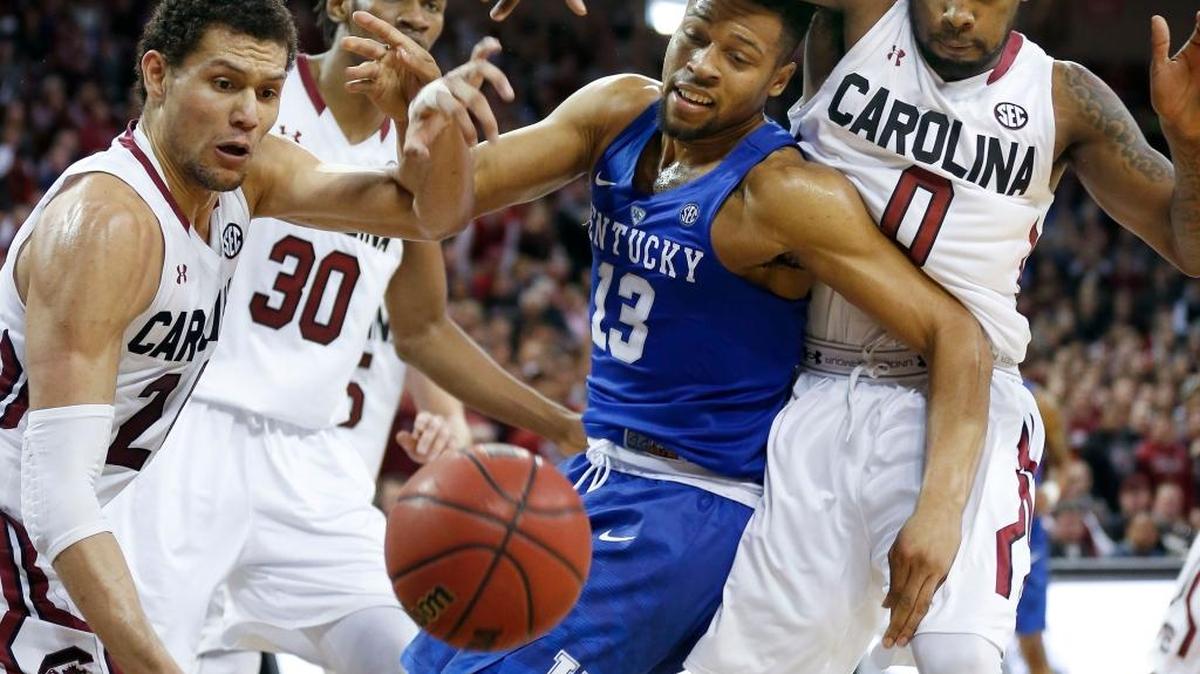 Kentucky Wildcats guard Isaiah Briscoe (13) battled South Carolina Gamecocks forward Michael Carrera (24), South Carolina Gamecocks forward Chris Silva (30), South Carolina Gamecocks guard Sindarius Thornwell (0) for a loose ball as the University of Kentucky played the University of South Carolina at Colonial Life Arena in Columbia, Sc., Saturday, February 13, 2016. This is second half men's college basketball action. UK won 89-62.