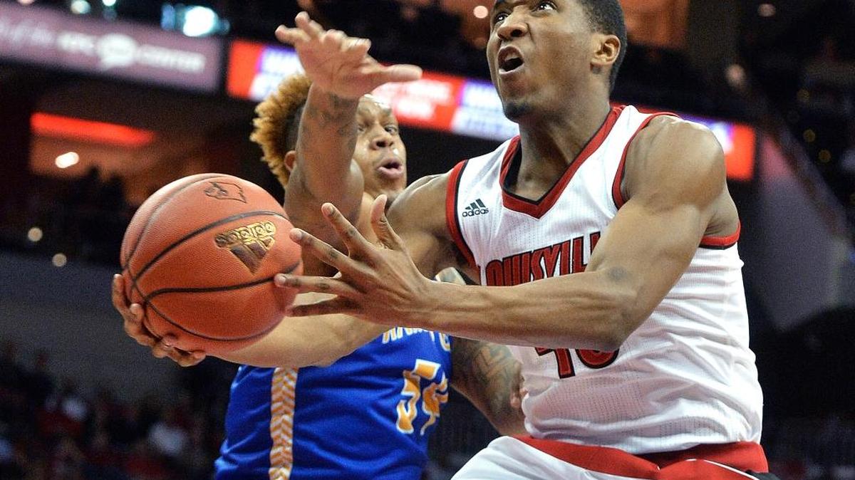 Louisville's Donovan Mitchell, right, goes to the basket past UMKC's Darnell Tillman during the second half of an NCAA college basketball game Tuesday, Dec. 22, 2015, in Louisville, Ky. Louisville won 75-47.