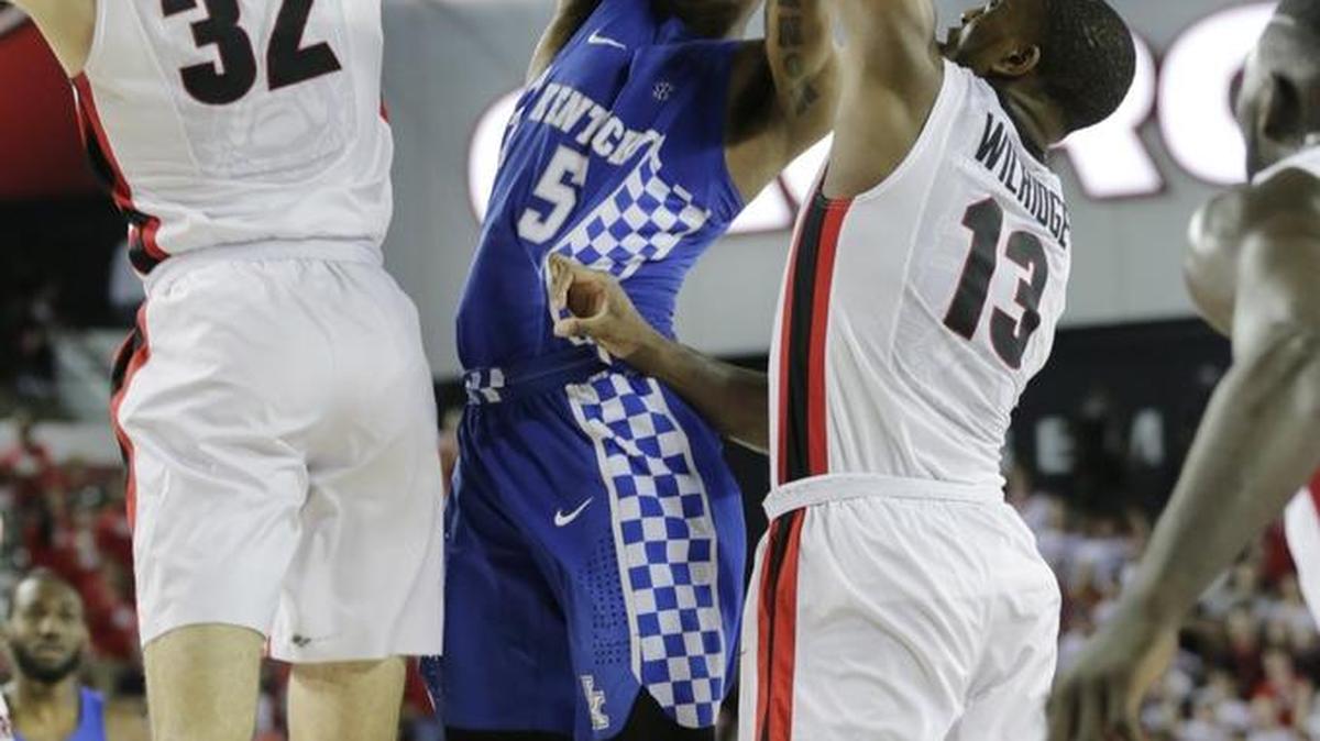 Kentucky guard Malik Monk (5) tries to split Georgia forwards Mike Edwards (32) left and E’Torrion Wilridge (13) in the second half of UK’s 82-77 win at Stegemen Coliseum in Athens, Ga., on Feb. 18, 2017.