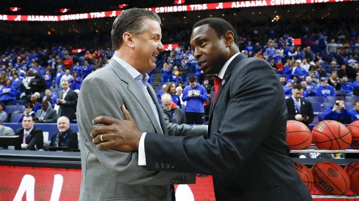 Kentucky head basketball coach John Calipari speaks with Alabama head basketball coach Avery Johnson before the SEC Tournament semifinals Saturday at the Scottrade Center in St. Louis. Kentucky defeated Alabama 86-63.