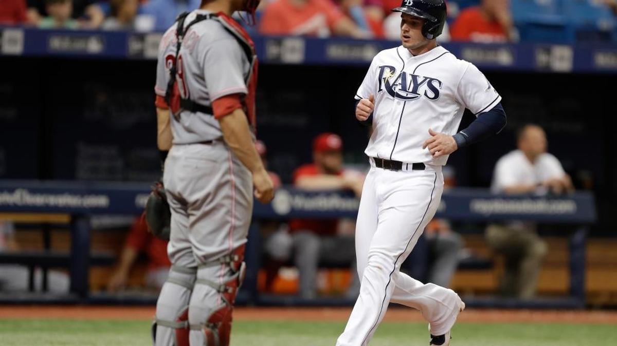 Tampa Bay Rays’ Daniel Robertson scores in front of Cincinnati Reds catcher Devin Mesoraco on a single by Mallex Smith during the fourth inning of Tampa Bay’s 8-3 win over the Reds on Wednesday, June 21, 2017, in St. Petersburg, Fla.