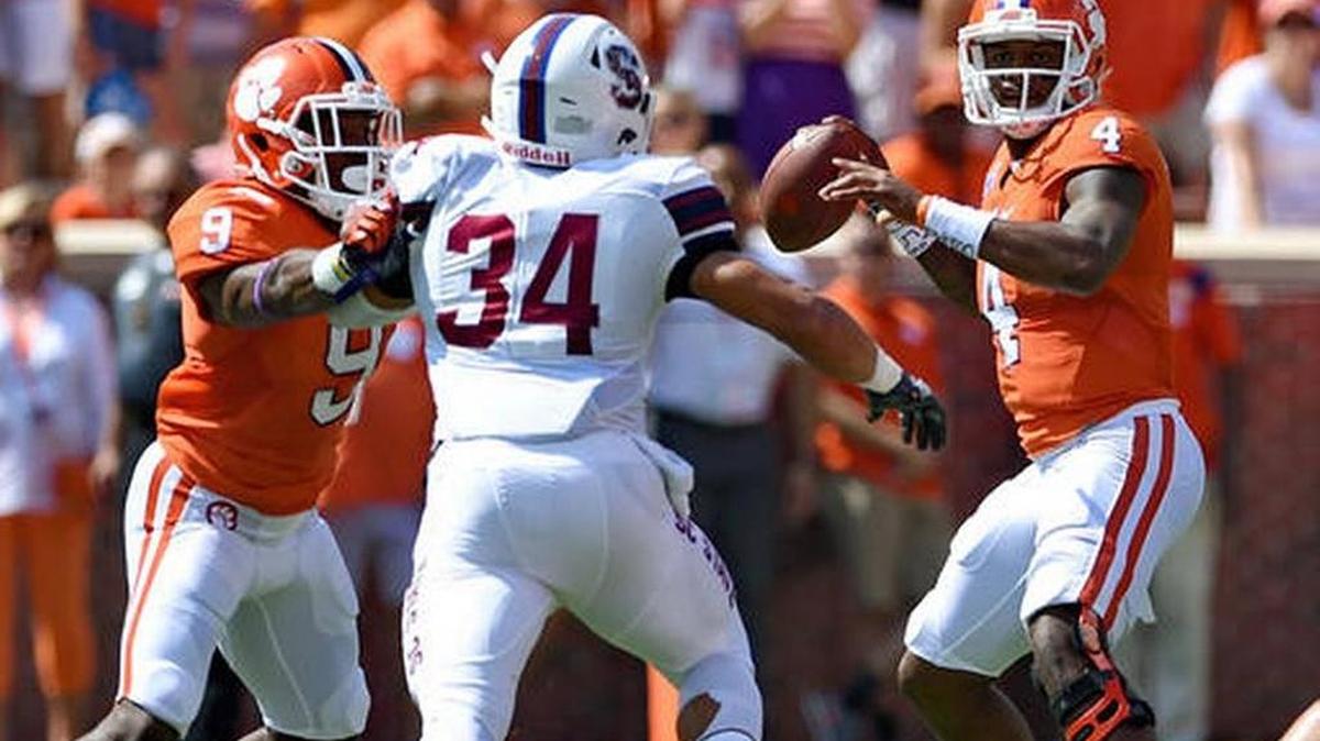 Clemson quarterback Deshaun Watson drops back to pass while pressured by South Carolina State's Dayshawn Taylor with blocking help from Wayne Gallman during the first half of an NCAA college football game Saturday, Sept. 17, 2016, in Clemson, S.C.