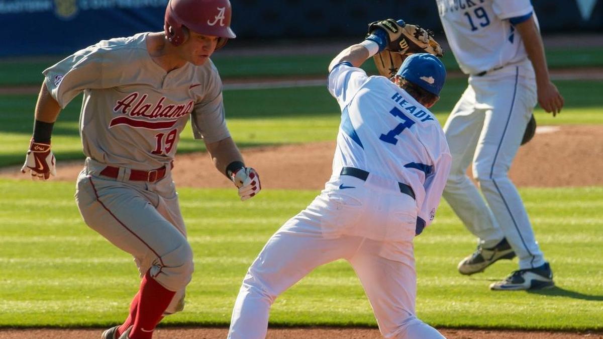 Alabama outfielder Hunter Webb (19) reaches first as Kentucky infielder Connor Heady (7) tries to catch the throw in the first round of the Southeastern Conference NCAA college baseball tournament in Hoover, Ala., Tuesday, May 24, 2016.