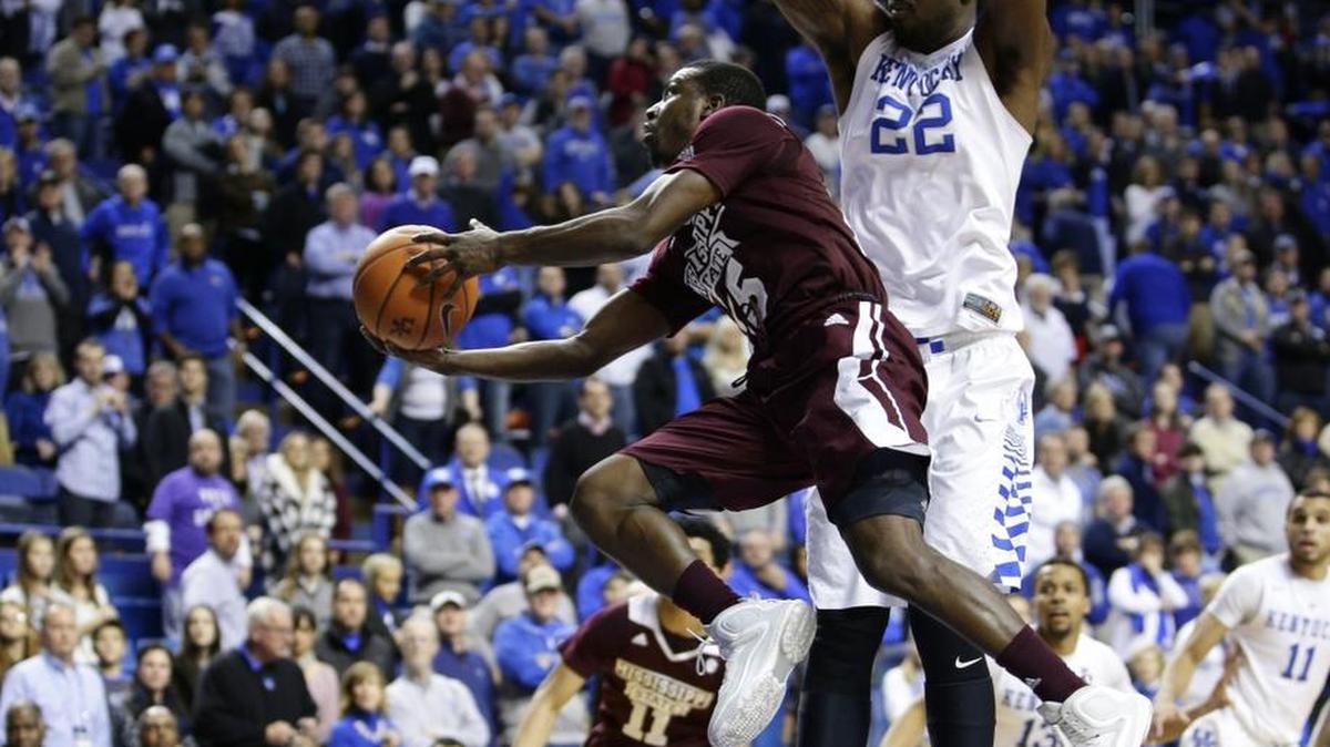 Mississippi State Bulldogs guard I.J. Ready (15) went under Kentucky Wildcats forward Alex Poythress (22) for a late basket as Kentucky defeated Mississippi State 80-74 on Tuesday January 12, 2016 in Lexington, Ky.