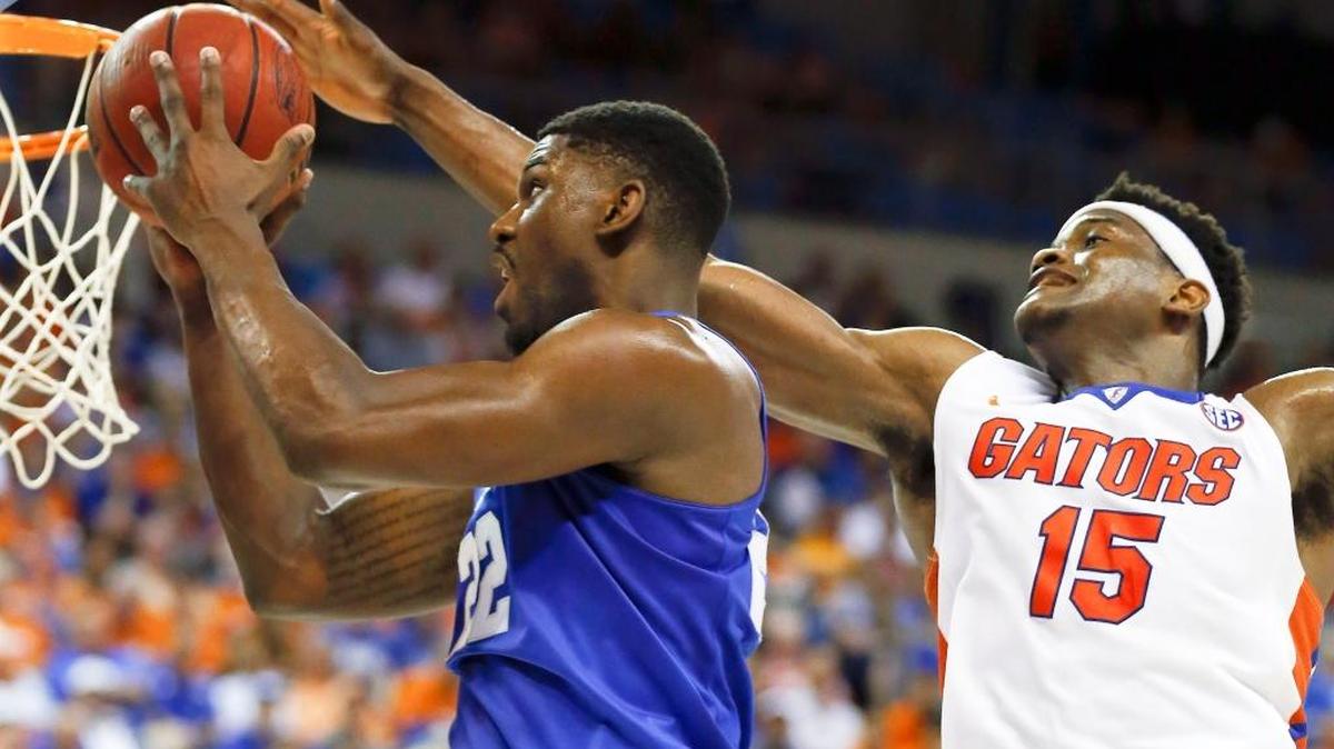 Kentucky Wildcats forward Alex Poythress (22) scored on a drive past Florida Gators center John Egbunu (15) as the University of Kentucky played the University of Florida at the O'Connell Center, Gainesville, Fl., Tuesday, March 1, 2016. This is second half action. UK won 88-79.
