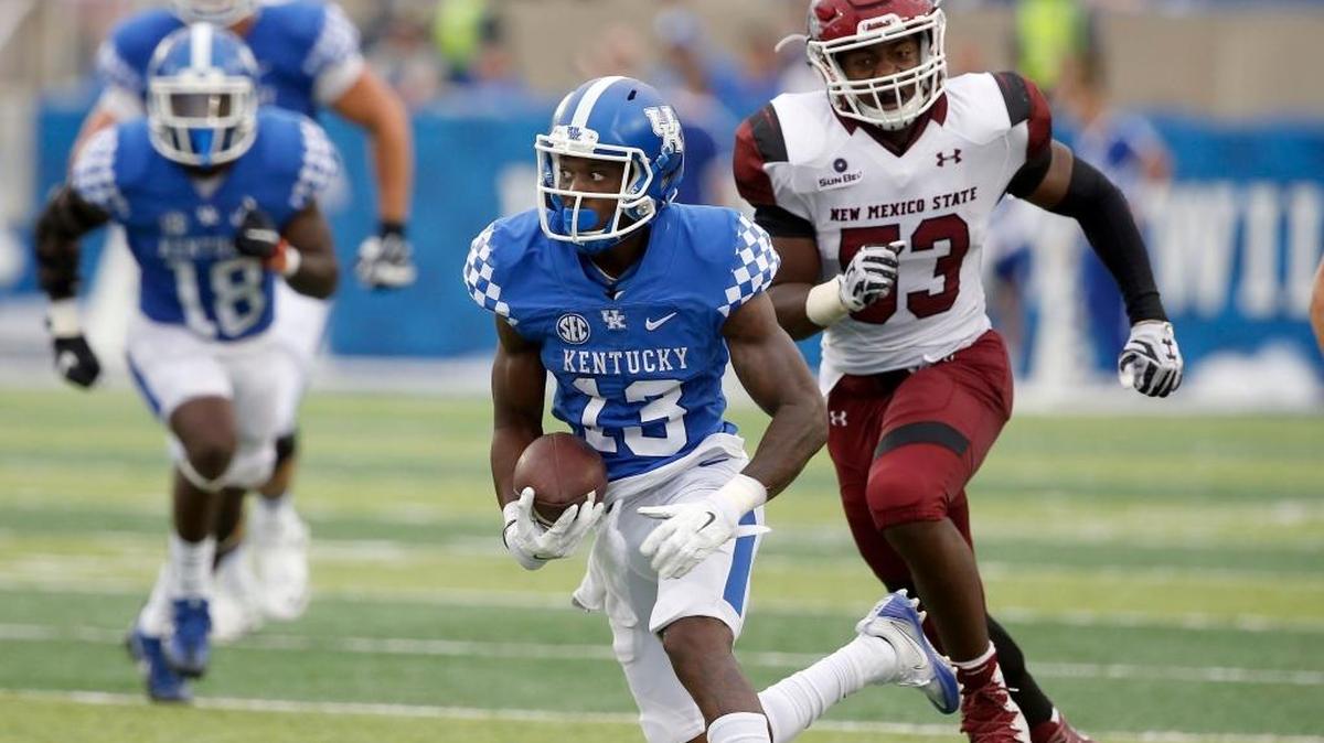 Kentucky wide receiver Jeff Badet (13) is chased by New Mexico State linebacker Rodney Butler (53)during UK’s 62-42 win over the Aggies at Commonwealth Stadium in Lexington, Ky., Saturday, September 17, 2016.
