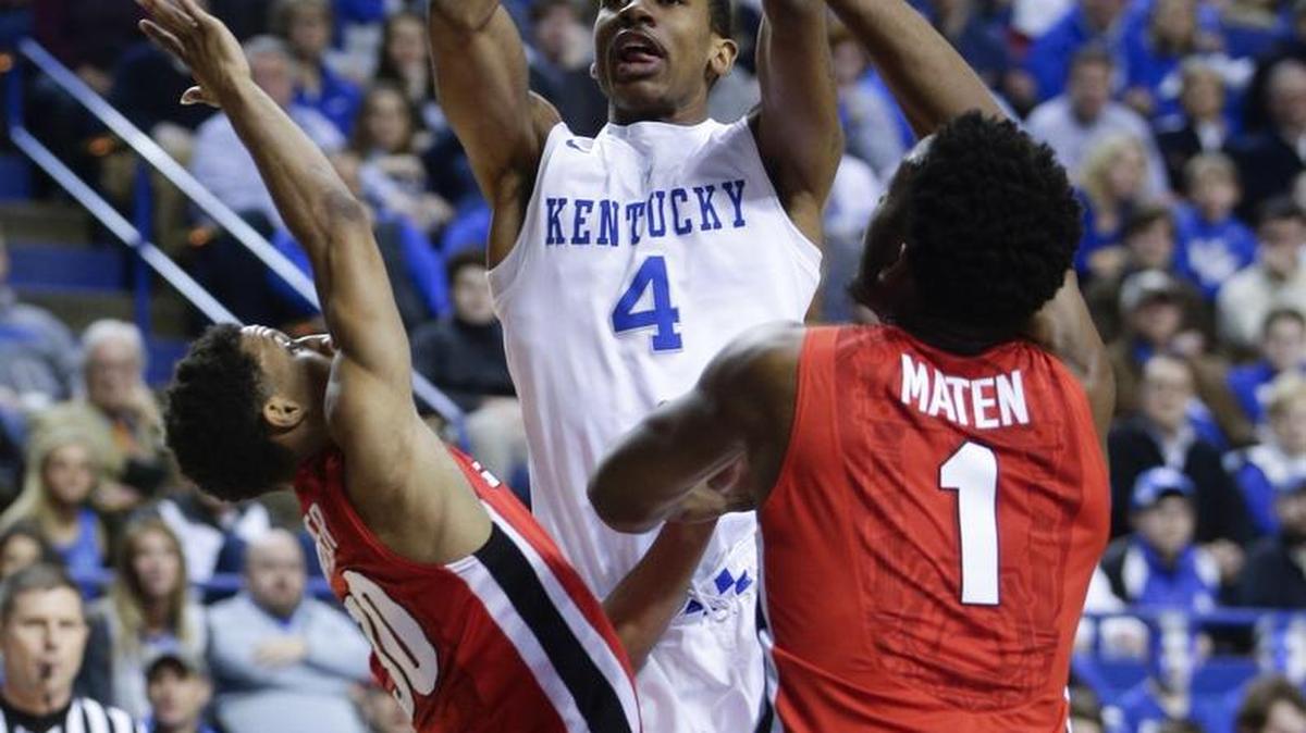 Kentucky guard Charles Matthews (4) scored over Georgia forward Yante Maten (1) as Kentucky played Georgia on Tuesday February 9, 2016 in Lexington, Ky.