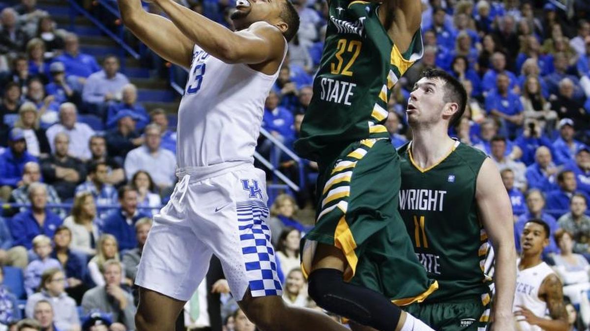 Kentucky Wildcats guard Isaiah Briscoe (13) underneath Wright State Raiders guard Joe Thomasson (32) for a basket as #2 Kentucky played Wright State on Friday November 20, 2015 in Lexington, Ky.