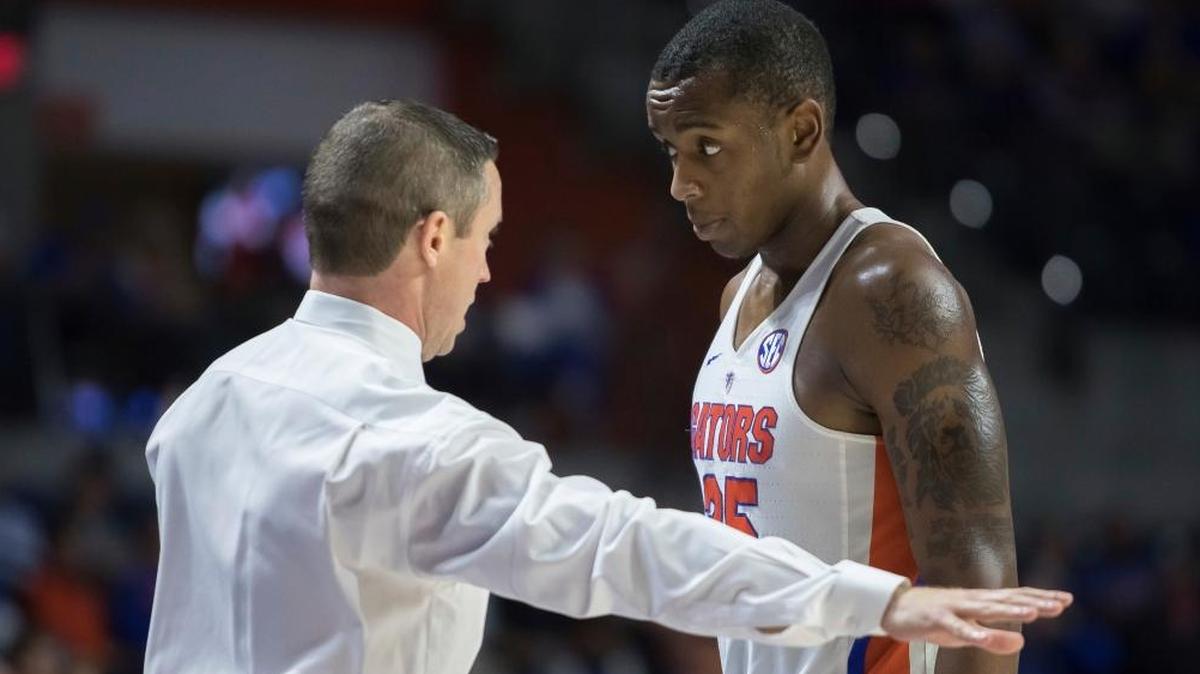 Florida head basketball coach Mike White talks with forward Keith Stone (25) during the second half of the Gators’ 65-59 loss to Loyola of Chicago in Gainesville, Fla., Wednesday, Dec. 6, 2017.