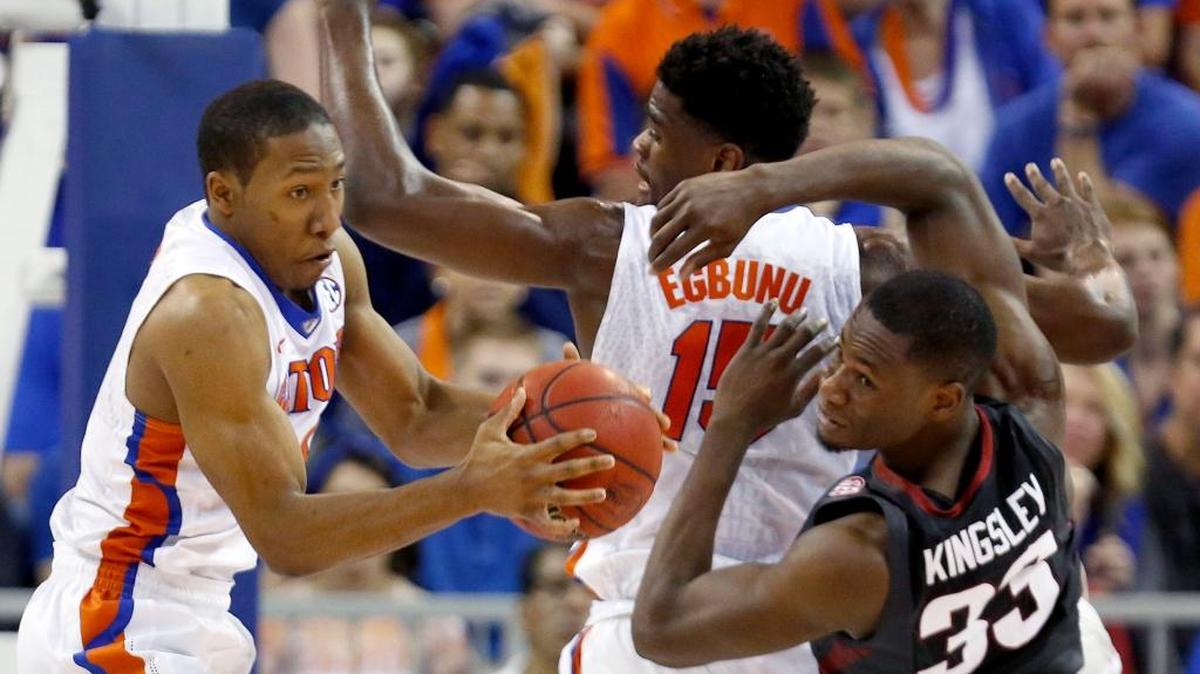 Florida guard KeVaughn Allen (4) grabs a rebound away from Arkansas forward Moses Kingsley (33) during the second half of an NCAA college basketball game at the O'Connell Center on Wednesday, Feb. 3, 2016 in Gainesville, Fla. Florida defeated Arkansas 87-83.