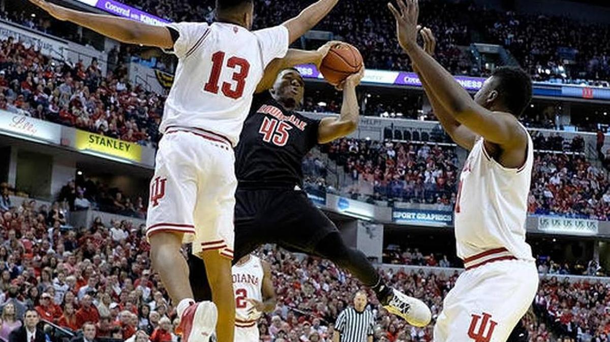 Louisville’s Donovan Mitchell gets off a shot around a pair of Indiana defenders during U of L’s win over the Hoosiers last Saturday in Indianapolis.