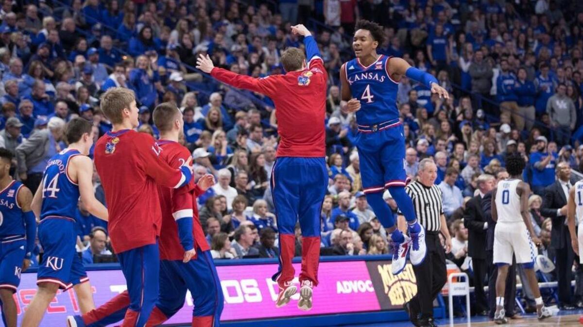 Kansas guard Devonte’ Graham (4) celebrated with a teammate during a timeout in the Jayhawks’ 79-73 win over Kentucky at Rupp Arena on Saturday Jan. 28, 2017 in Lexington, Ky.