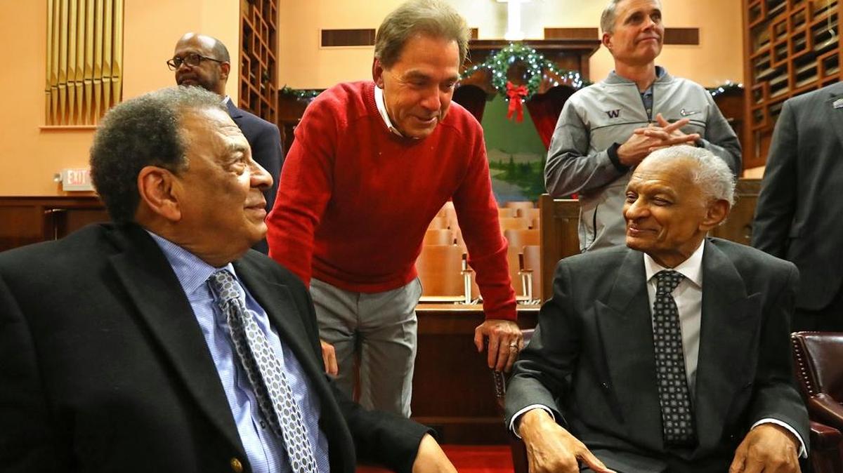 Alabama coach Nick Saban, in red, and Washington coach Chris Peterson, top right, greet Andrew Young, seated left, and C.T. Vivian at the conclusion of a tour of the Martin Luther King Jr. National Historic Site to hear first-hand accounts from civil rights leaders at the Historic Ebenezer First Baptist Church on Tuesday, Dec. 27, 2016, in Atlanta.