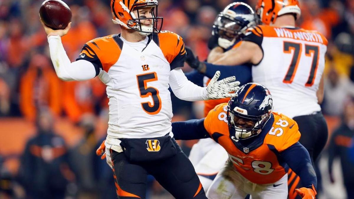 Cincinnati Bengals quarterback AJ McCarron (5) throws as Denver Broncos outside linebacker Von Miller (58) pursues during the second half of an NFL football game, Monday, Dec. 28, 2015, in Denver.