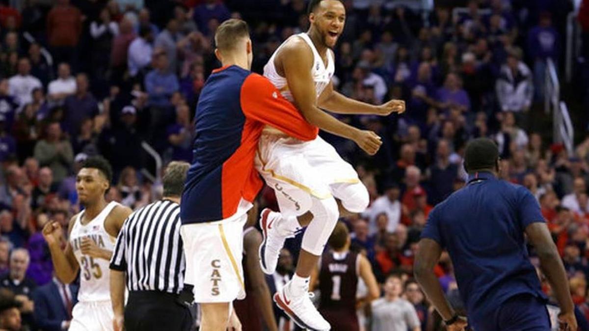 Arizona guard Parker Jackson-Cartwright, right, celebrates with a teammate after defeating seventh-ranked Texas A&M 67-64 on Tuesday, Dec 5, 2017, in Phoenix.