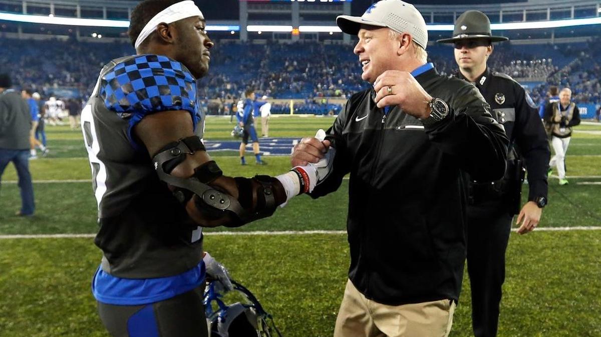 Kentucky head coach Mark Stoops went to hug running back Boom Williams (18) after UK beat Mississippi State 40-38 on Saturday, October 8, 2016.