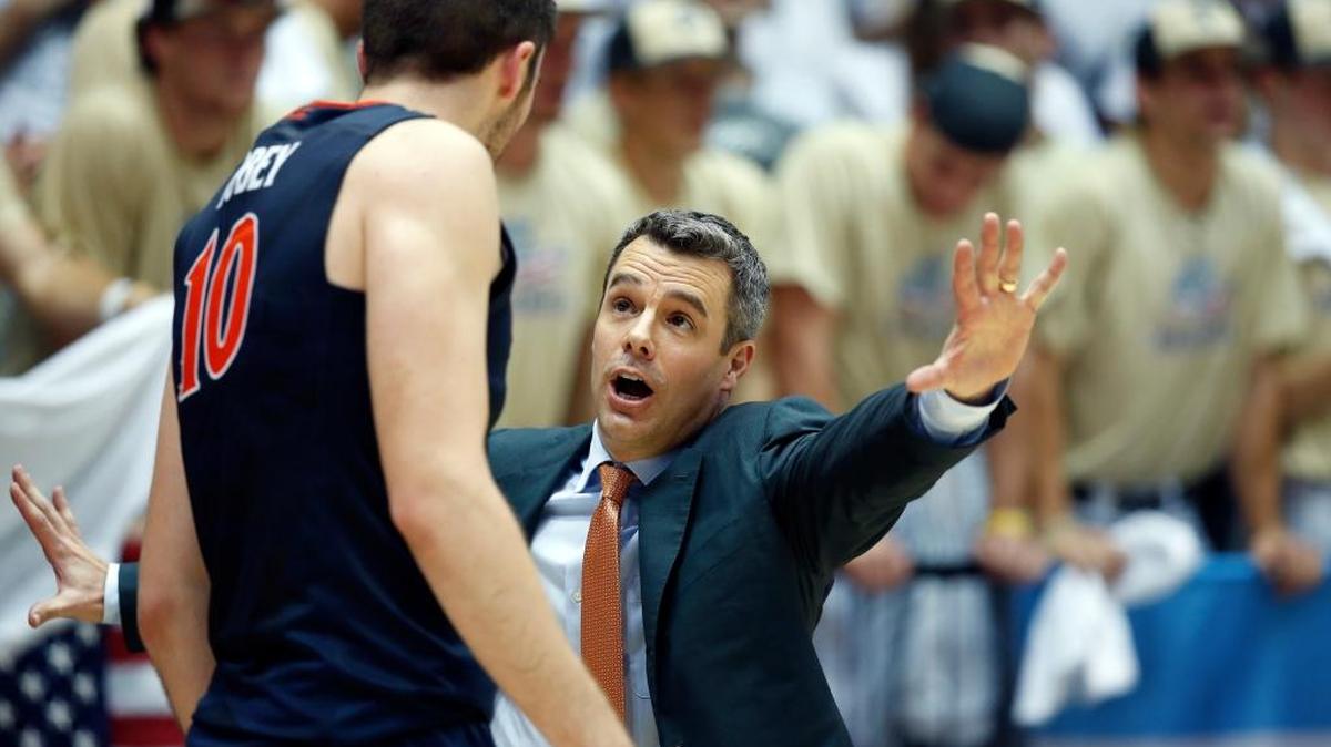 Virginia center Mike Tobey (10) listens to Virginia head coach Tony Bennett during the second half of an NCAA college basketball game against George Washington, Monday, Nov. 16, 2015, in Washington. George Washington won 73-68.
