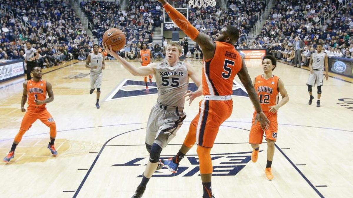 Xavier's J.P. Macura (55) shoots against Auburn's Cinmeon Bowers (5) in the first half of an NCAA college basketball game, Saturday, Dec. 19, 2015, in Cincinnati. Xavier won 85-61.
