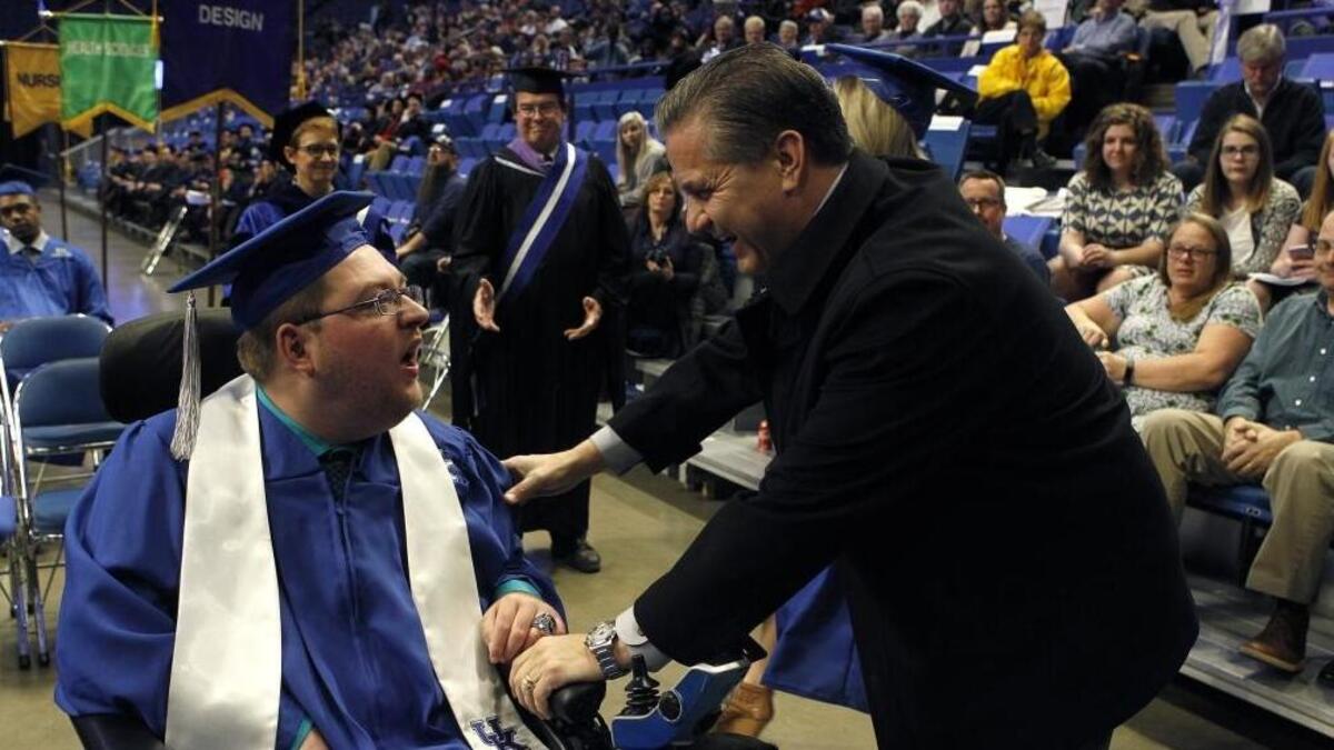 UK men’s basketball coach John Calipari congratulates the team’s student manager Kevin Massey after he was awarded his bachelor’s degree during commencement exercises for the University of Kentucky at Rupp Arena in Lexington, Ky., Friday, December 15, 2017. Calipari gives assistant coach John Robic the credit for mentoring Massey.