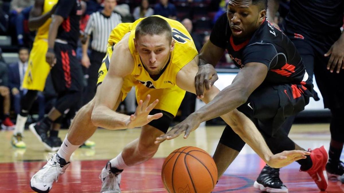 Iowa forward Jarrod Uthoff (20) and Rutgers forward Jonathan Laurent (4) compete for the ball during the first half of an NCAA college basketball game, Thursday, Jan. 21, 2016, in Piscataway, N.J.