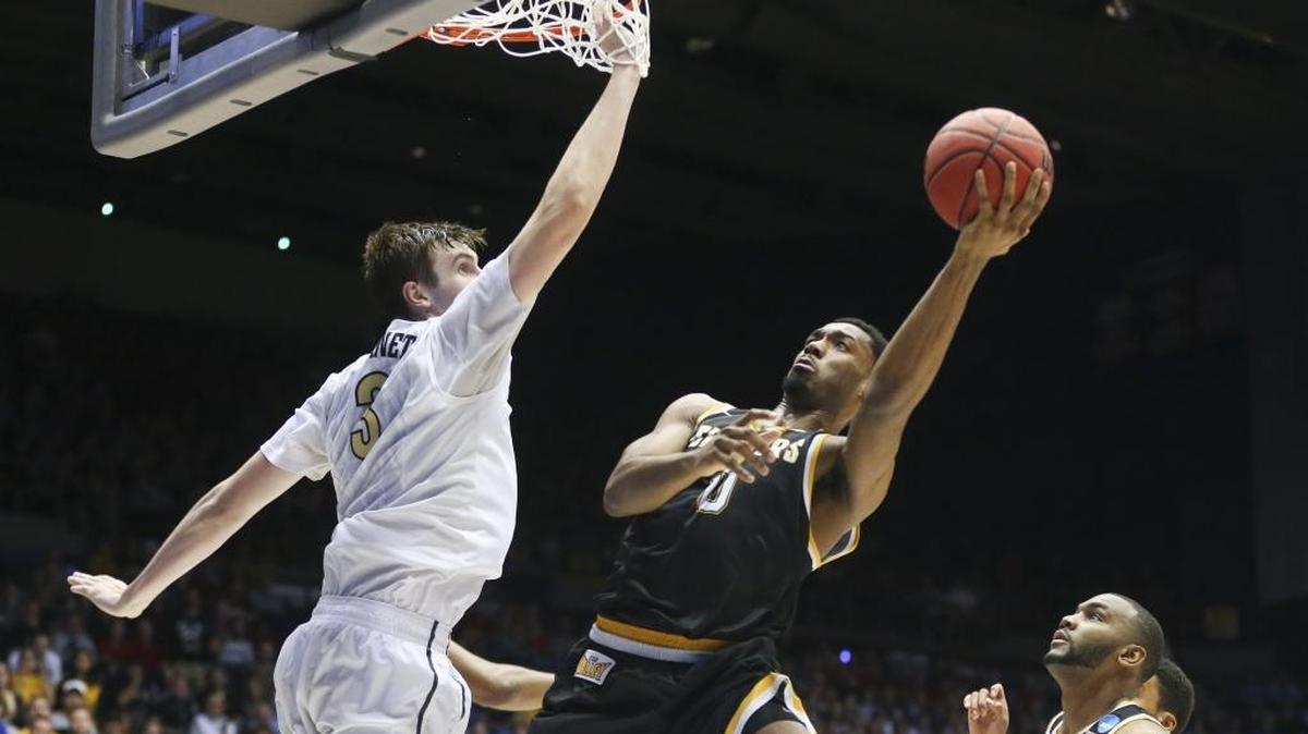 Wichita State's Rashard Kelly goes to the basket against Vanderbilt's Luke Kornet, left, during the second half in the opening round of the NCAA Tournament at UD Arena in Dayton, Ohio, on Tuesday, March 15, 2016. Wichita State advanced, 70-50.