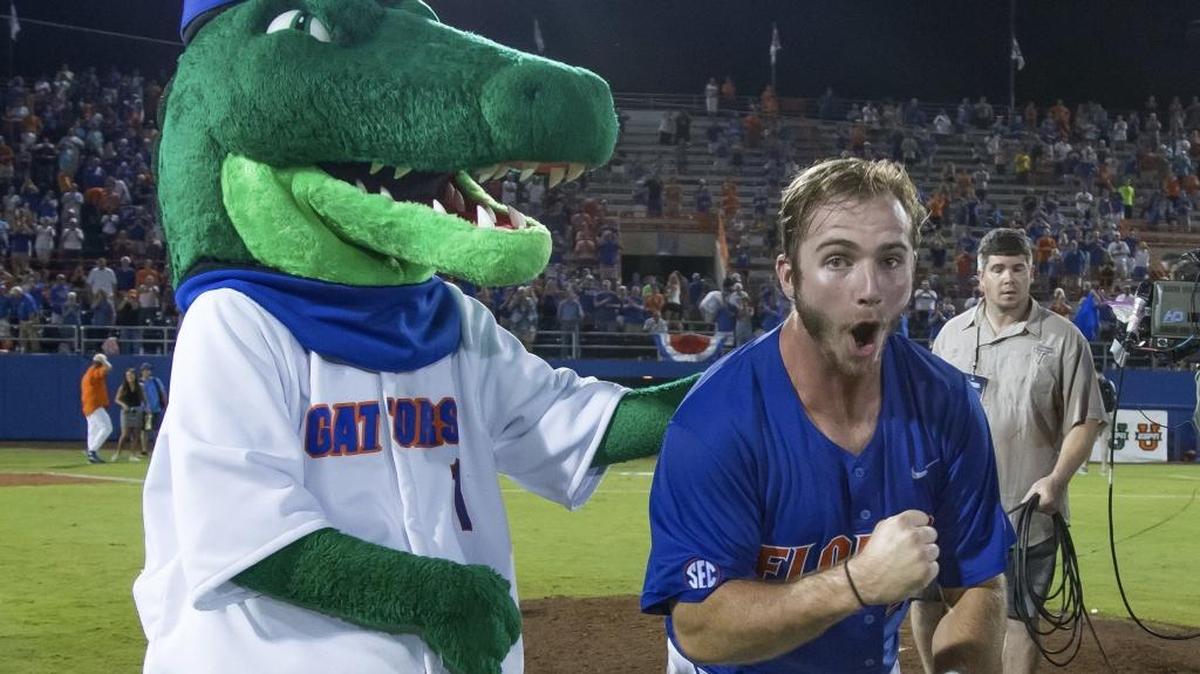 Florida first baseman Peter Alonso celebrates Florida's 7-0 victory over Florida State with Florida mascot Albert after Game 3 of an NCAA college baseball tournament super regional in Gainesville, Fla., on Monday, June 13, 2016.