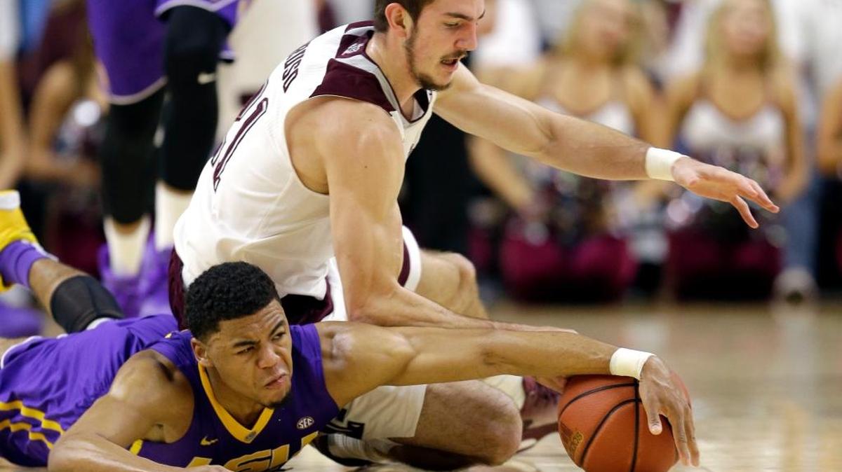 Texas A&M's Alex Caruso, top, and LSU's Jalyn Patterson scramble for a loose ball during the second half of an NCAA college basketball game Tuesday, Jan. 19, 2016, in College Station, Texas.