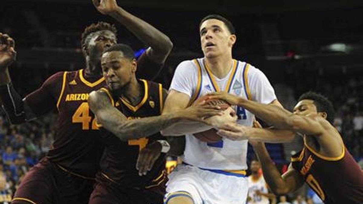 UCLA guard Lonzo Ball is fouled while driving against Arizona State's Jethro Tshisumpa, Torian Graham and Tra Holder, from left, during UCLA;s 102-80 victory in Los Angeles, Thursday, Jan. 19, 2017.