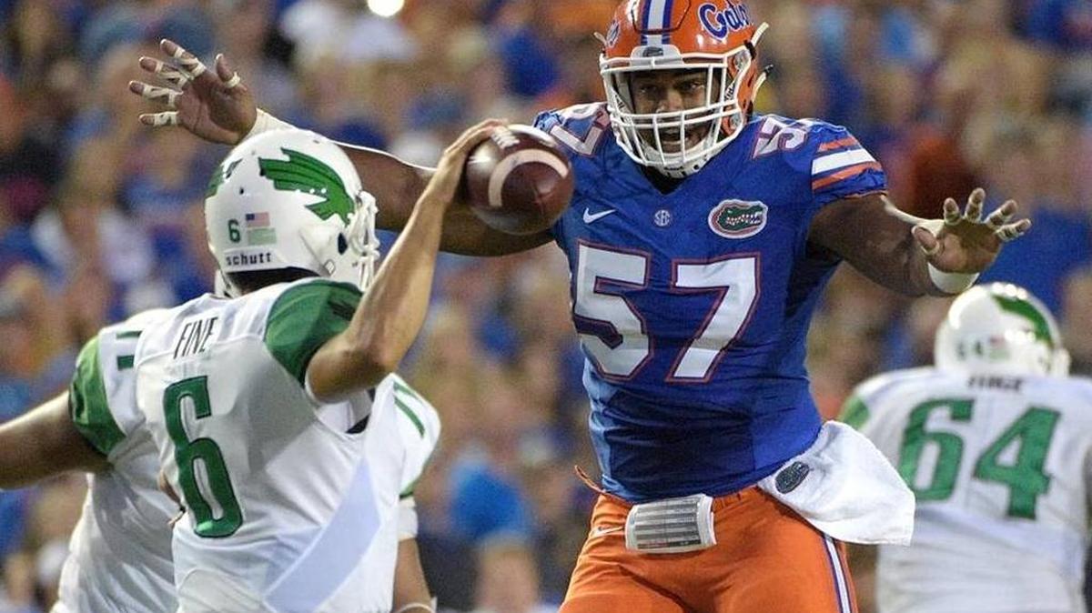 Florida defensive lineman Caleb Brantley (57) pressures North Texas quarterback Mason Fine during the first half of Saturday’s game, during which Brantley sacked Fine in the end zone for a safety.