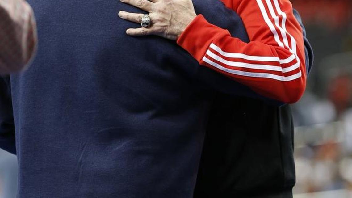 Head coach Rick Pitino hugged UL athletic director Tom Jurich after the University of Louisville practice in the Georgia Dome Friday April 5, 2013, in Atlanta. Louisville went on to win the national championship on Monday, April 7, 2013.