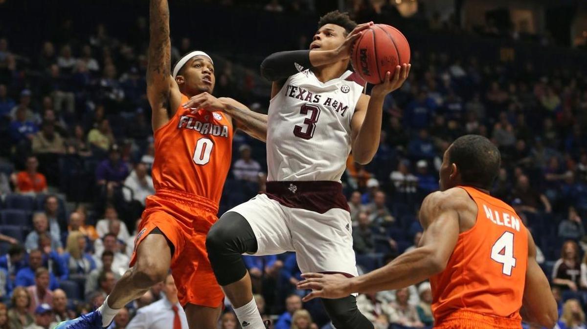 Texas A&M's Admon Gilder (3) drives between Florida's Kasey Hill (0) and KeVaughn Allen (4) during the first half of an NCAA college basketball game in the Southeastern Conference tournament in Nashville, Tenn., Friday, March 11, 2016.
