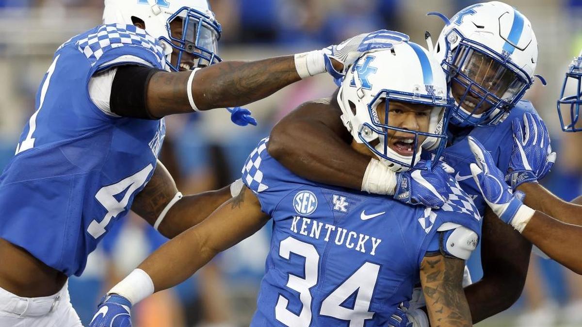 Kentucky defensive ends Josh Allen (41), left, and Denzil Ware (35), right, congratulated linebacker Jordan Jones (34) after Jones made a sack during UK’s 20-13 win over Vanderbilt at Commonwealth Stadium in Lexington, Ky., Saturday, October 8, 2016.