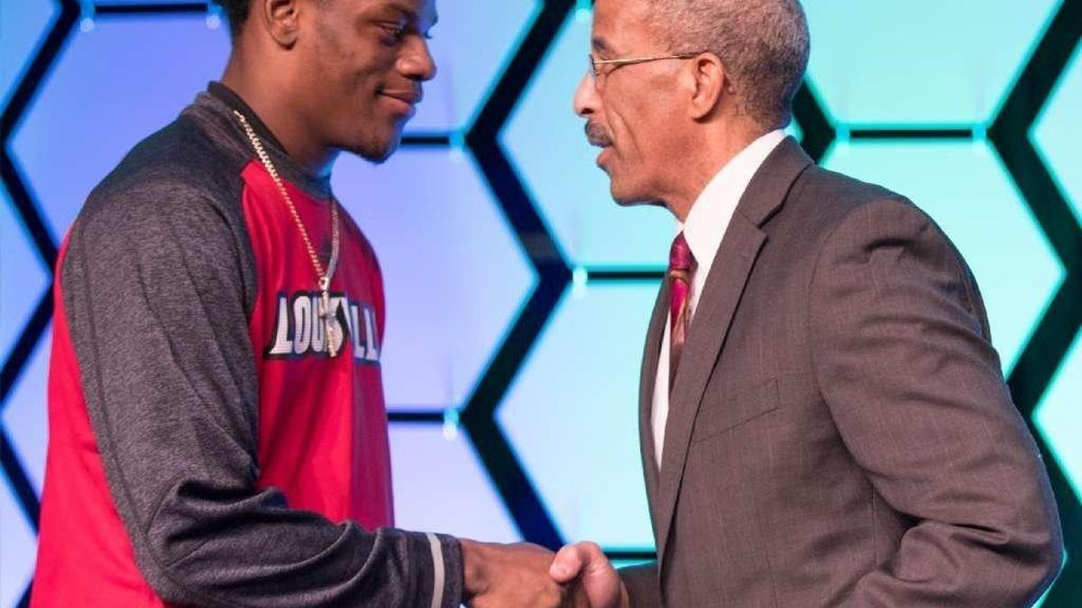 Lexington Herald-Leader publisher Rufus Friday, right, congratulates Louisville quarterback Lamar Jackson for winning the Herald-Leader’s Kentucky Sports Figure of the Year award for 2016.