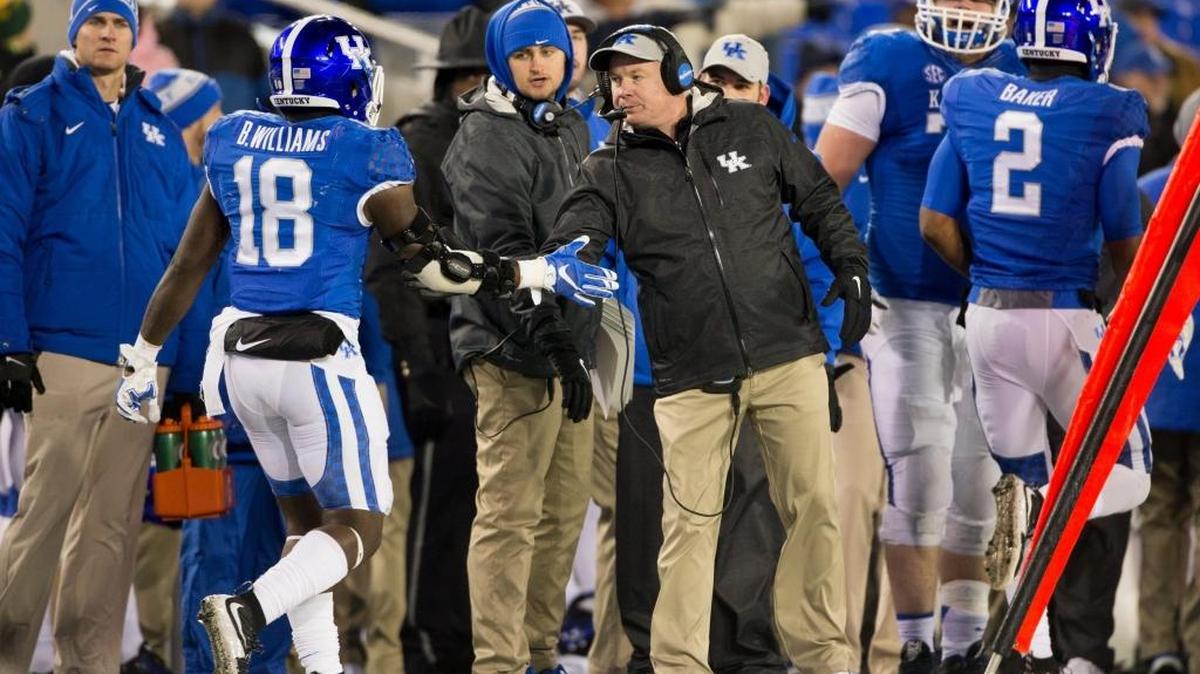 Kentucky head coach Mark Stoops , right congratulates running back Boom Williams after scoring a touchdown in the third quarter. Kentucky whipped Charlotte 58-10 on Saturday, Nov. 21, 2015 at Commonwealth Stadium in Lexington.